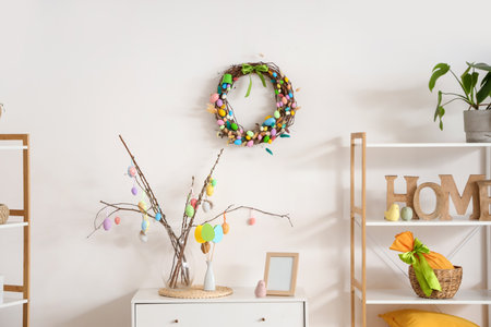 Interior of living room decorated for Easter with wreath and willow branches in vaseの写真素材