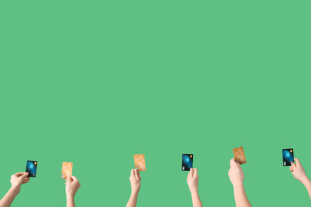 Women with credit cards on green background