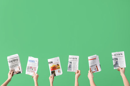Women with newspapers on green backgroundの写真素材
