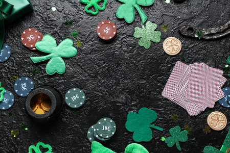 Frame made from poker chips, cards and decorations for St. Patrick's Day celebration on black backgroundの写真素材