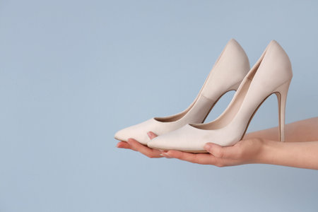 Woman with stylish heels on light backgroundの写真素材