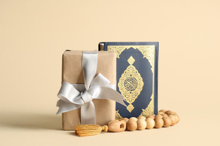 Gift box with prayer beads and Koran for Ramadan on beige backgroundの写真素材