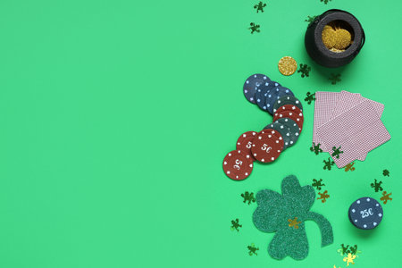 Poker chips, pot with coins, cards and clover on green background. St. Patrick's Day celebrationの写真素材