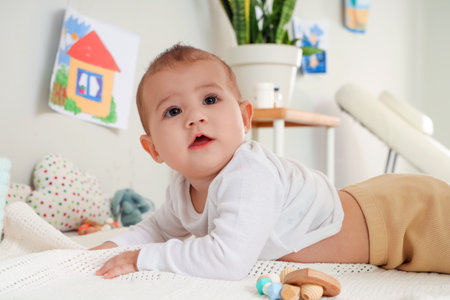 Little baby lying on table in clinicの写真素材