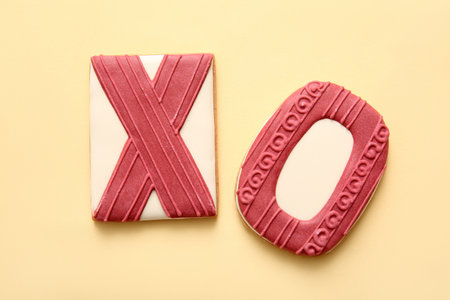 Sweet cookies in shape of XO symbol on yellow background. Valentine's Day celebrationの写真素材