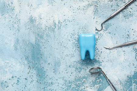 Dental tools and tooth model on grunge blue background. World Dentist Dayの写真素材