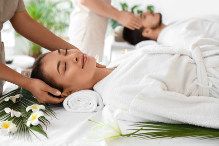 Young Asian woman with her husband relaxing in spa salonの写真素材