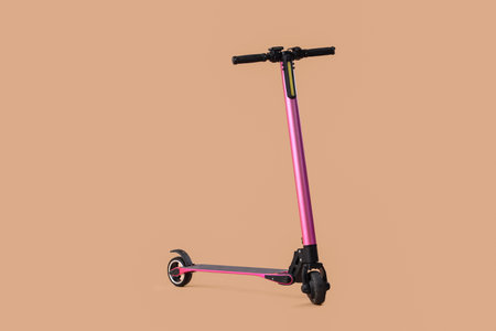 Pink modern electric kick scooter on brown backgroundの写真素材