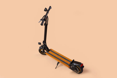 Modern electric kick scooter on brown backgroundの写真素材