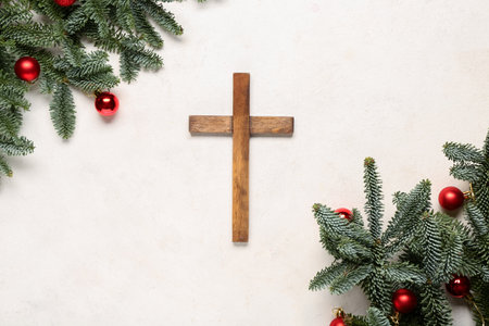 Cross with fir branches and balls on white grunge background. Concept of Christmas storyの写真素材