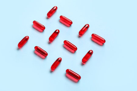 Composition with red capsules on color backgroundの写真素材