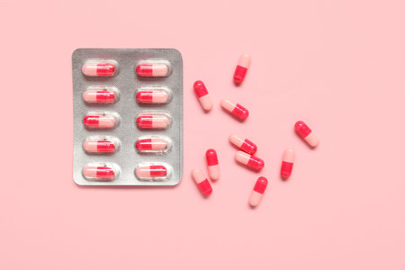 Blister pack with pills on pink background