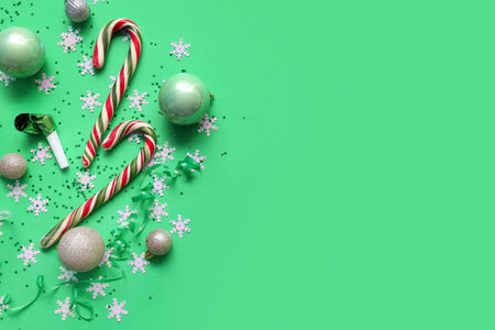 Candy cane, Christmas balls and confetti on green backgroundの写真素材