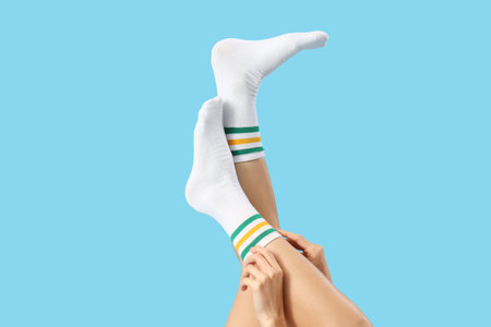 Woman in white socks on blue backgroundの写真素材