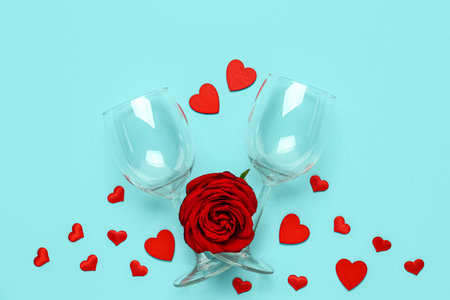 Composition with wine glasses for Valentine's day on blue background