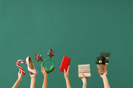 Female hands with shoe, bags and Christmas decor on green background. New year shopping conceptの写真素材