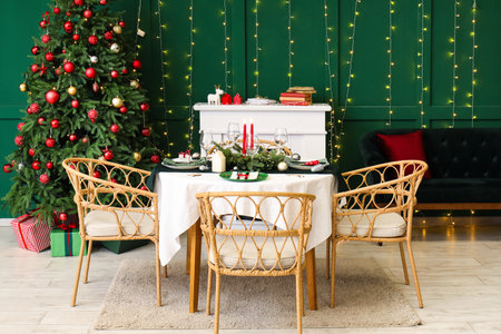 Festive table setting in stylish living room with Christmas tree and fireplaceの写真素材