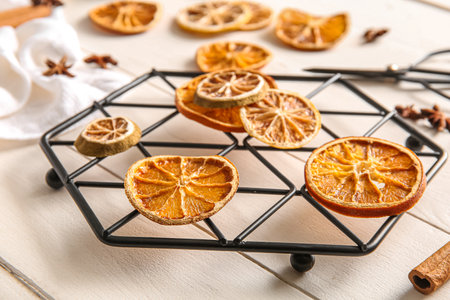 Stand with dried orange slices on white wooden backgroundの写真素材