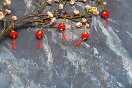 Sakura branch with Chinese symbols on blue grunge background. New Year celebrationの写真素材