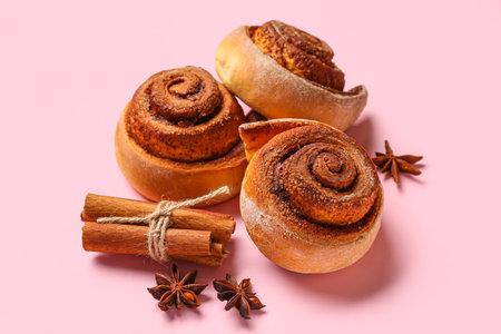 Tasty cinnamon rolls on pink backgroundの写真素材