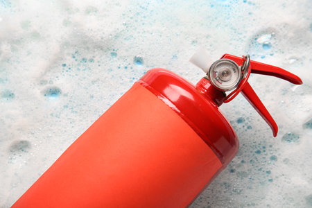 Fire extinguisher with foam on blue backgroundの写真素材