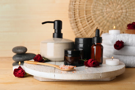 Beautiful spa composition with rose flowers on wooden backgroundの写真素材