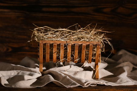Manger with hay on wooden background. Concept of Christmas storyの写真素材
