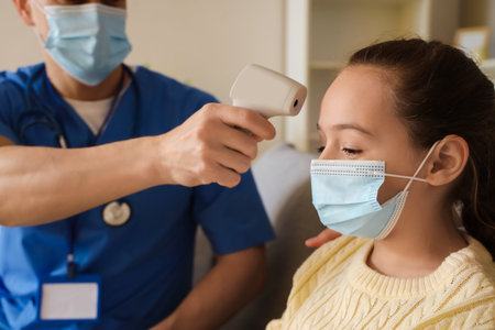 Doctor measuring temperature of ill little girl at home, closeup