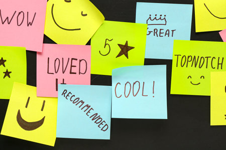 Sticky papers with reviews on dark background. Customer experience conceptの写真素材
