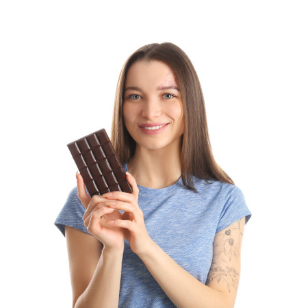 Beautiful young woman with chocolate bar on white backgroundの写真素材