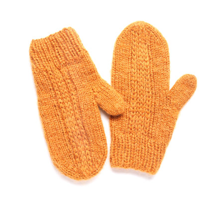 Pair of orange warm knitted mittens on white backgroundの写真素材