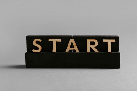 Black blocks with word START on gray background