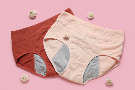 Composition with period panties and beautiful flowers on pink backgroundの写真素材