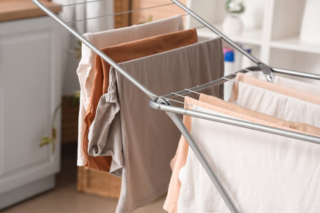 Dryer with clean clothes in laundry room, closeupの写真素材