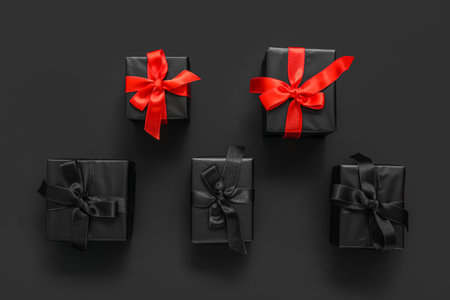 Many gift boxes on dark background. Black Friday
