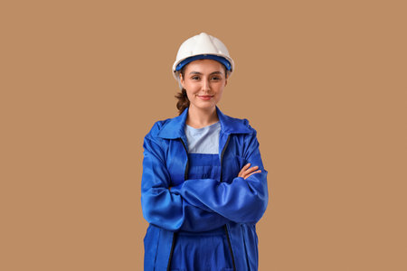 Female worker in uniform on brown backgroundの写真素材