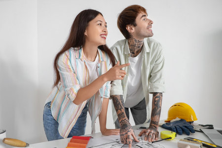 Young couple planning renovation in their new house