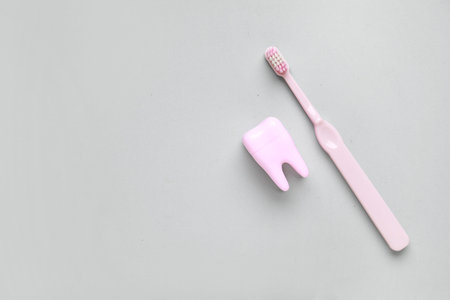 Tooth model with electric toothbrush on white background. World Dentist Day