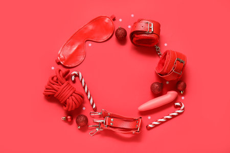 Frame made of different sex toys with Christmas balls and candy canes on red backgroundの写真素材