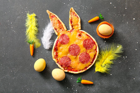 Composition with tasty pizza and Easter eggs on black backgroundの写真素材