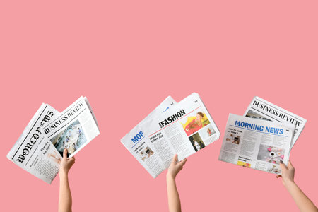 Women with newspapers on pink backgroundの写真素材