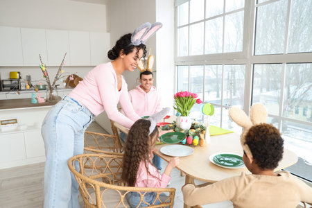 Happy family having dinner in kitchen on Easter Day