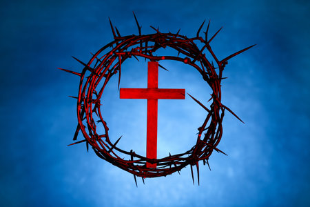 Crown of thorns with wooden cross and red light on blue backgroundの写真素材