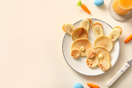 Funny Easter bunny pancakes with painted eggs on white backgroundの写真素材