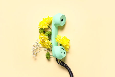 Retro telephone with beautiful gypsophila and chrysanthemum flowers on yellow background. International Women's Dayの写真素材