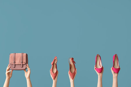 Women with stylish shoes and bag on blue backgroundの写真素材