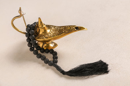 Aladdin lamp with prayer beads for Ramadan on white grunge backgroundの写真素材