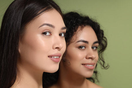 Beautiful women on green background, closeupの写真素材