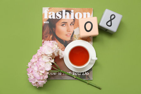 Cube calendar with date 08, beautiful hydrangea flowers, magazine and cup of tea on green background. International Women's Dayの写真素材