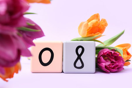 Cube calendar with date 08 and beautiful tulips on lilac background. International Women's Day
